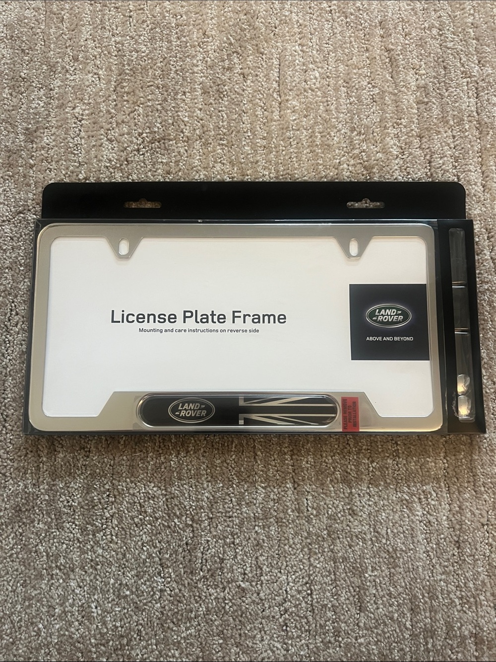 Silver License Plate Frame with Branded Badge